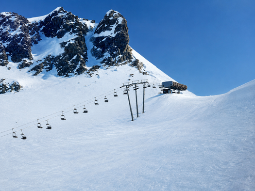 Artist’s impression of the Colletto Verde chairlift approaching its upper station beneath a rocky ridge.