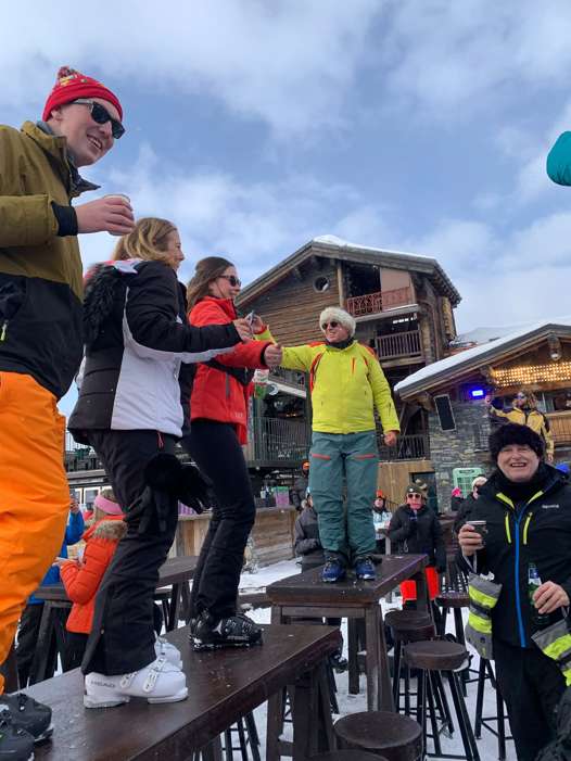 Friends enjoying the outdoor après-ski atmosphere at La Folie Douce in Val d’Isère.