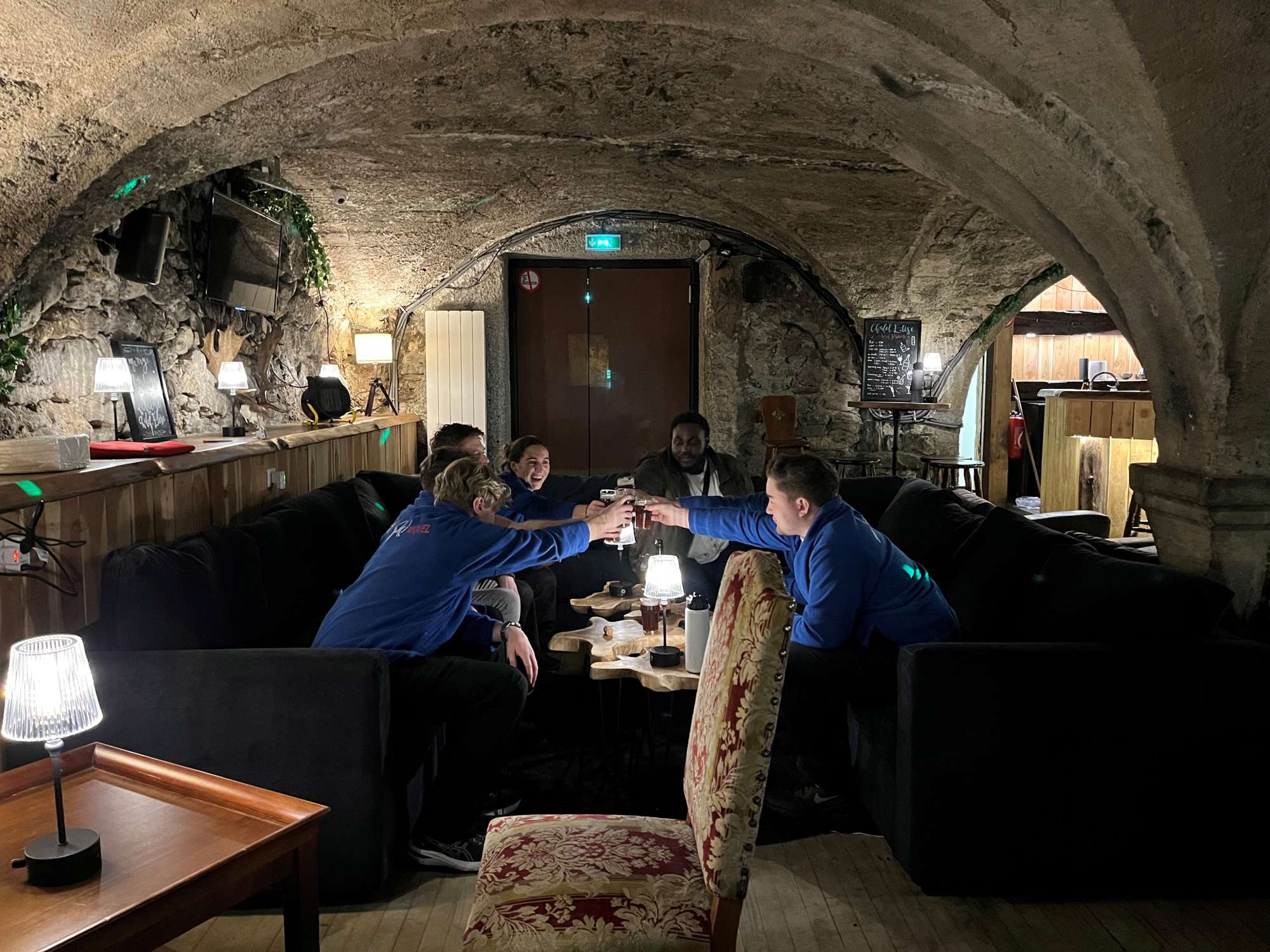 Taken 12 Dec 2023 in Montgenèvre by Max Ski Miquel team drinking on the sofa Elise bar saying cheers