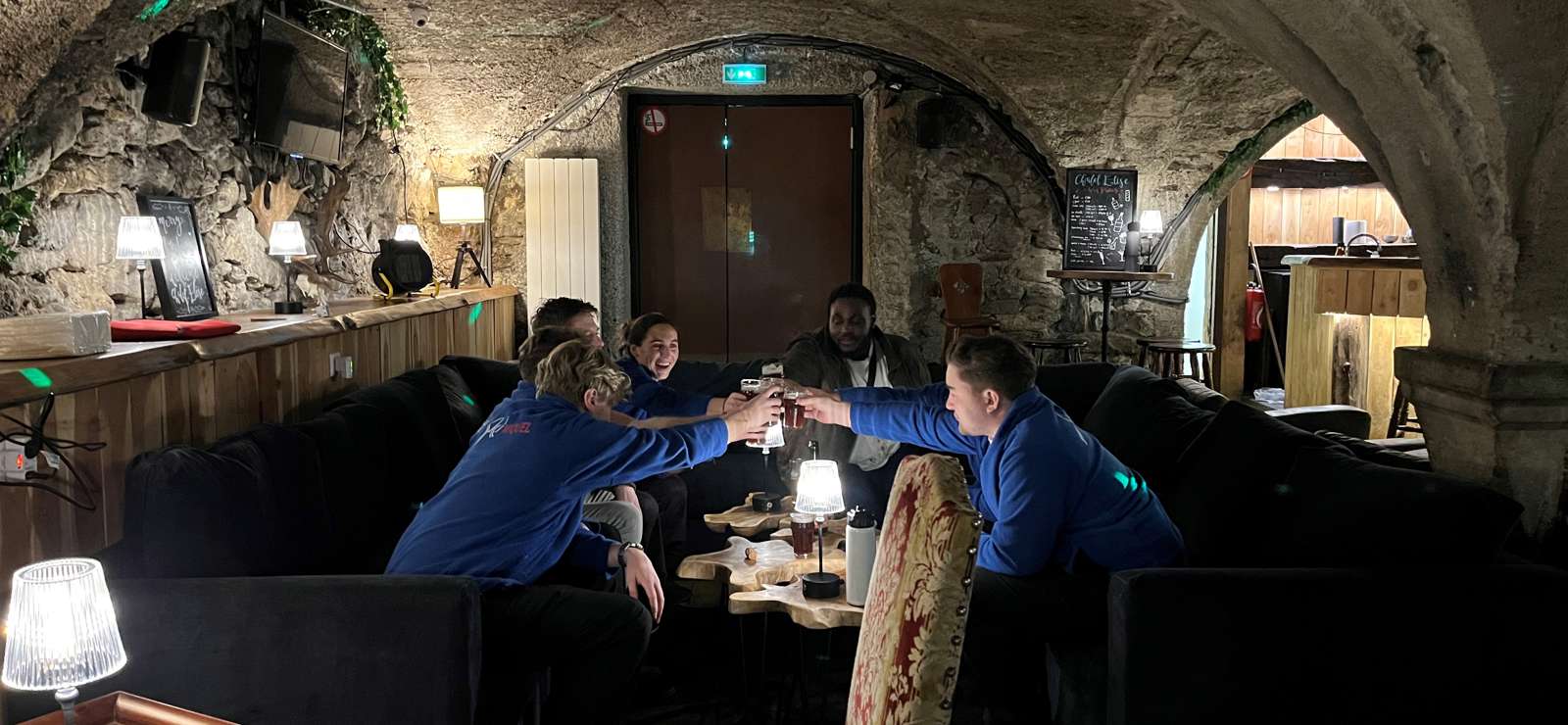 Taken 12 Dec 2023 in Montgenèvre by Max Ski Miquel team drinking on the sofa Elise bar saying cheers