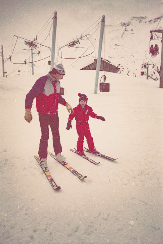 Ralph skiing beside his dad during a childhood holiday