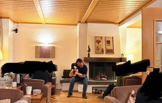 Dean resort manager in the Rosa lounge playing guitar 