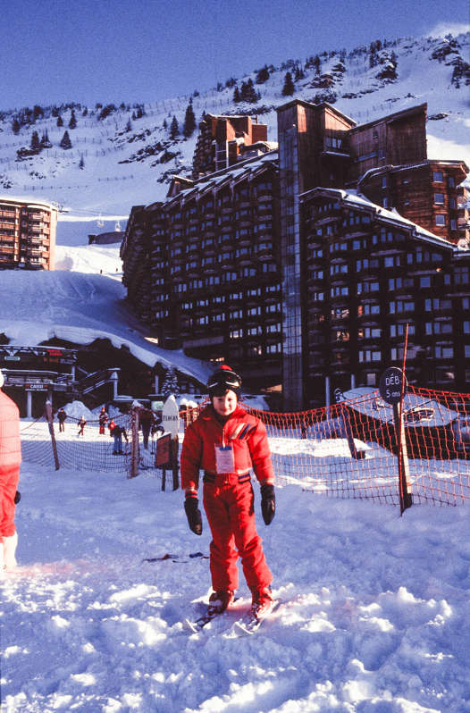 Young Ralph Johnson in a red ski suit on a childhood skiing holiday
