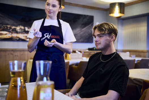 ski Miquel staff member taking an order