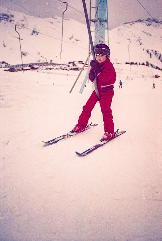 Young Ralph riding a drag lift on a childhood ski holiday