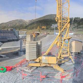 Construction of the new Chalvet gondola station in Montgenèvre, with a crane and groundwork underway.
