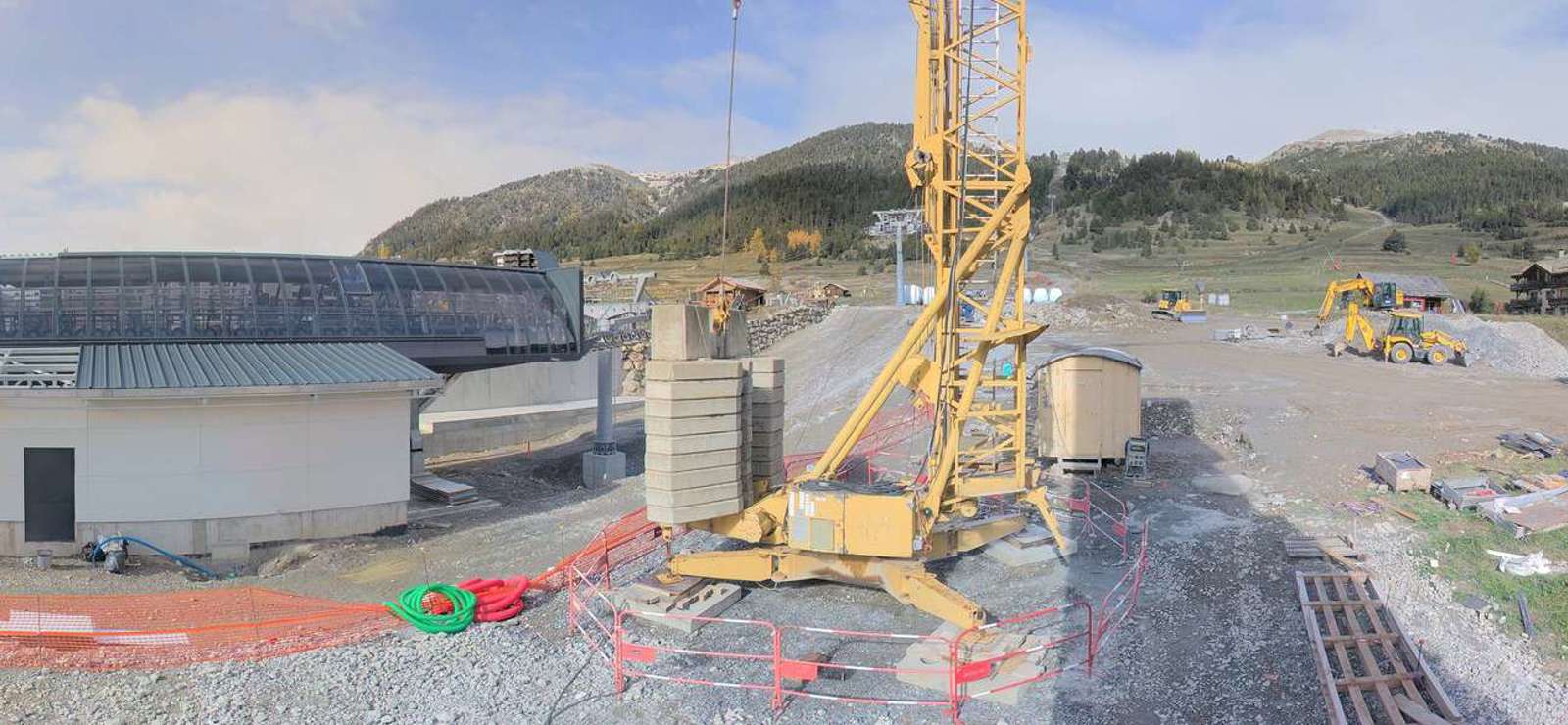 Construction of the new Chalvet gondola station in Montgenèvre, with a crane and groundwork underway.